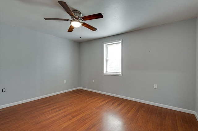 spare room featuring hardwood / wood-style flooring and ceiling fan