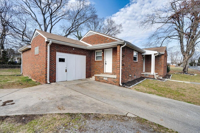 view of side of property with a yard and a garage