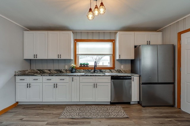 kitchen featuring appliances with stainless steel finishes, sink, and white cabinets