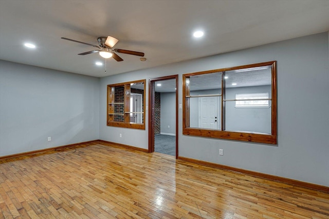 spare room featuring ceiling fan and light wood-type flooring