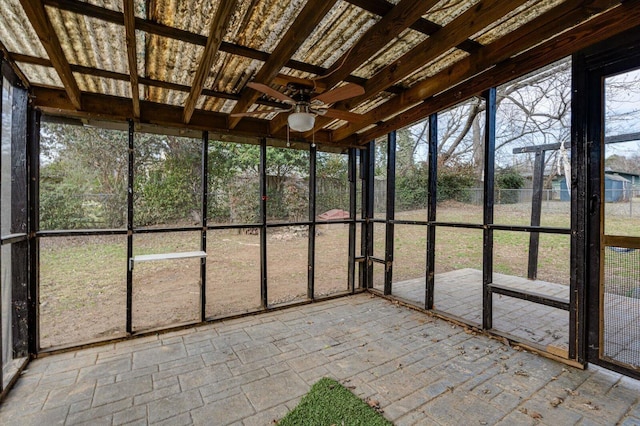 unfurnished sunroom featuring ceiling fan