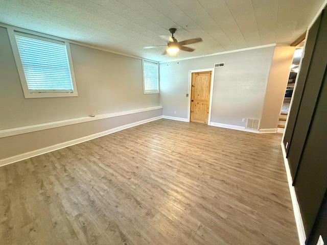 spare room with hardwood / wood-style flooring, ceiling fan, and ornamental molding