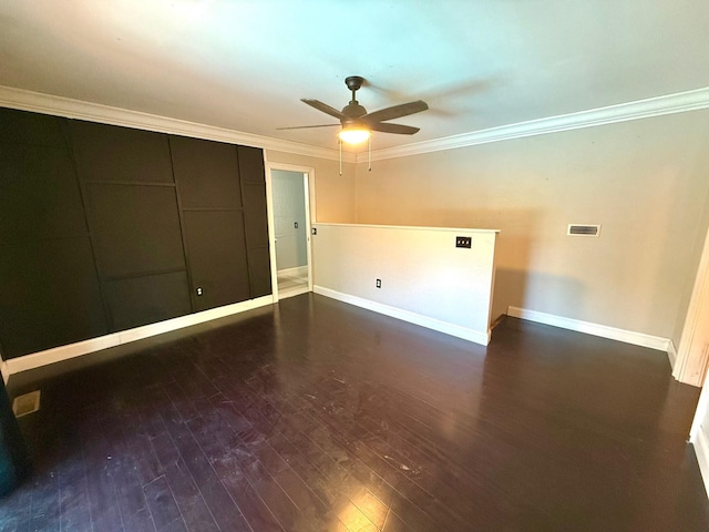 spare room with dark wood-type flooring, ceiling fan, and ornamental molding