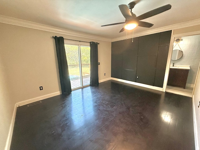 empty room with ornamental molding, ceiling fan, and dark hardwood / wood-style flooring