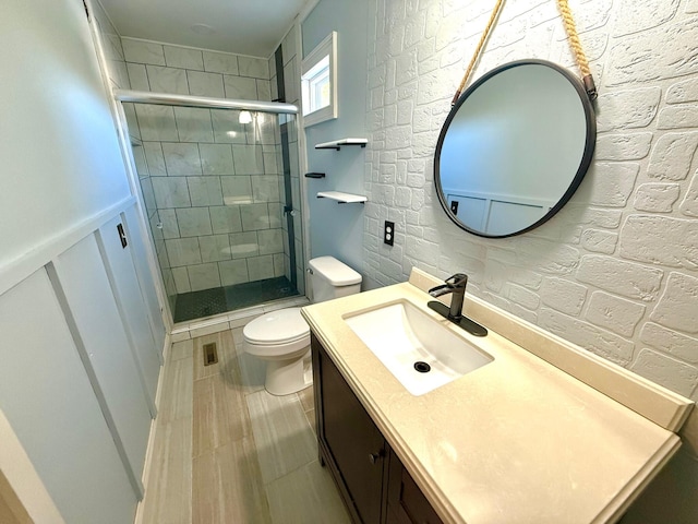 bathroom with vanity, an enclosed shower, and toilet