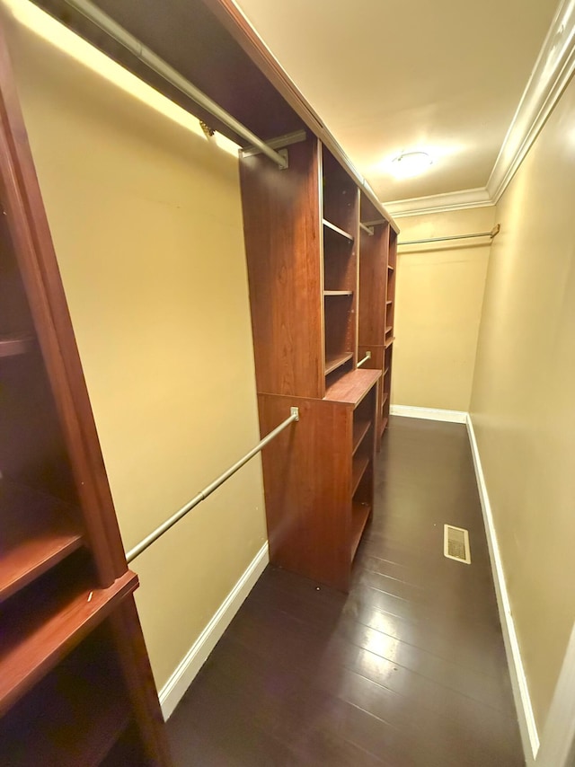 spacious closet with dark hardwood / wood-style floors