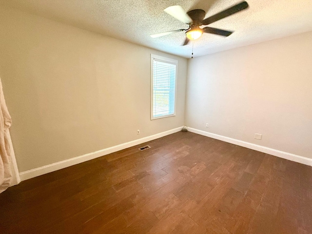 empty room with ceiling fan, a textured ceiling, and dark hardwood / wood-style flooring