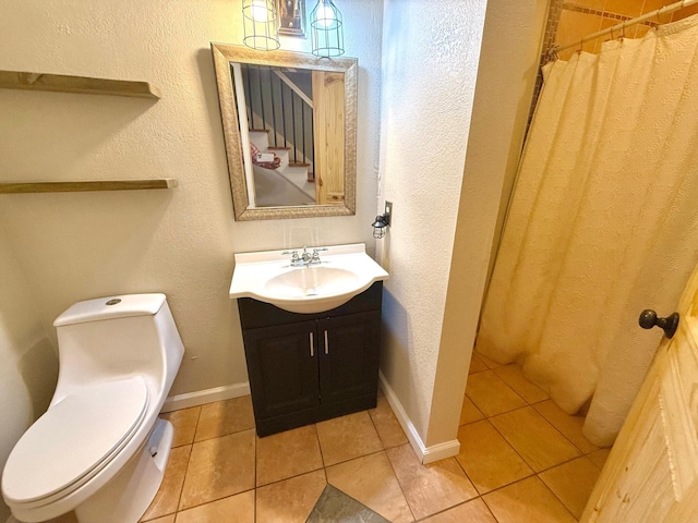 bathroom with walk in shower, vanity, toilet, and tile patterned flooring