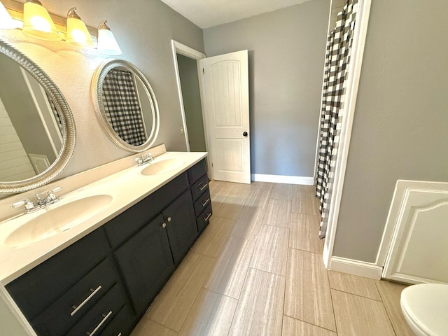 bathroom featuring vanity and toilet