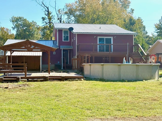 back of house featuring a pool side deck and a yard