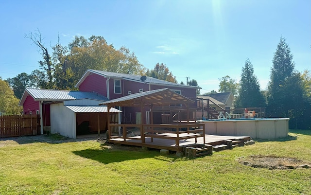 back of house featuring a pool side deck and a lawn