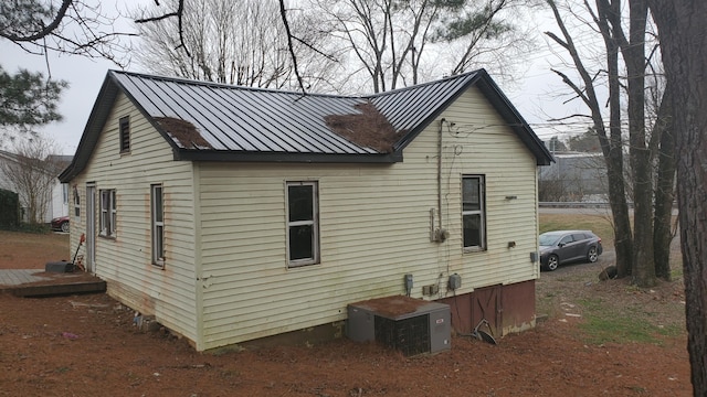 view of side of property featuring central AC