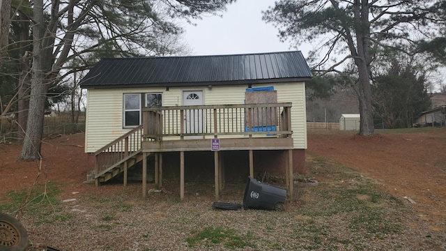 back of property featuring a wooden deck