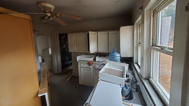 kitchen with white cabinetry and ceiling fan