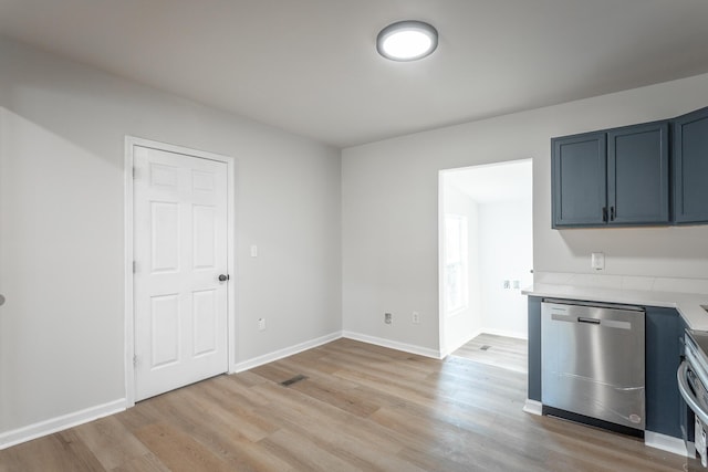 kitchen featuring stainless steel dishwasher, light hardwood / wood-style floors, and range