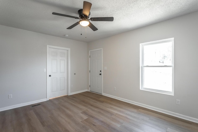 unfurnished room featuring ceiling fan, a textured ceiling, and light hardwood / wood-style flooring