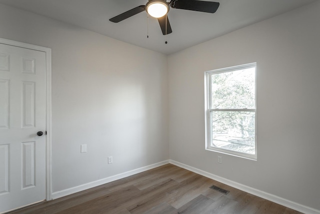 empty room featuring hardwood / wood-style flooring and ceiling fan