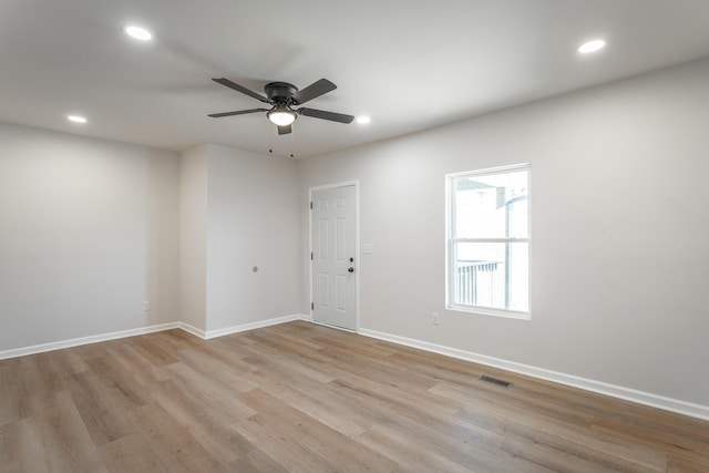 empty room with ceiling fan and light wood-type flooring