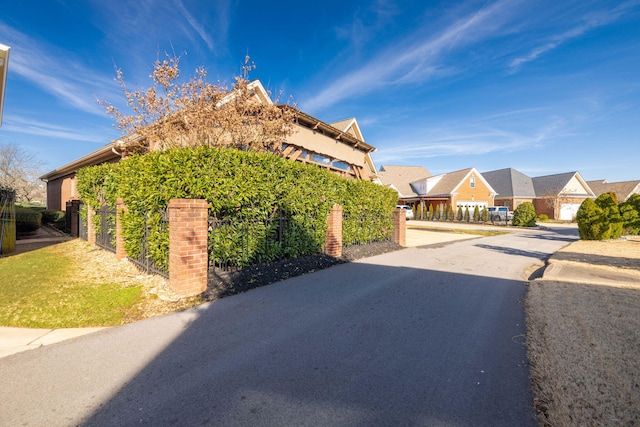 view of side of property with fence and a residential view