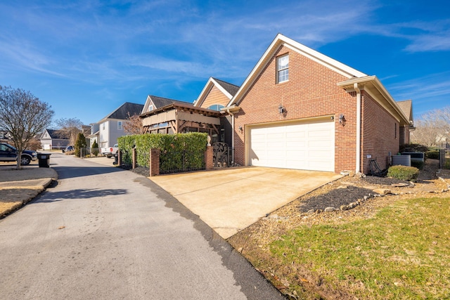 view of front of house with cooling unit, a residential view, concrete driveway, a garage, and brick siding