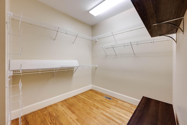 walk in closet featuring visible vents and light wood finished floors
