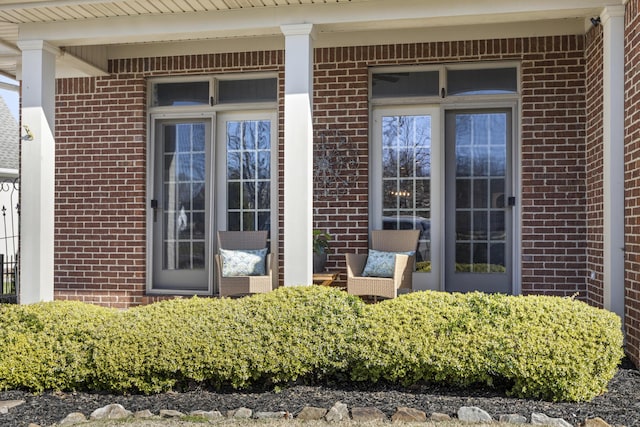 property entrance featuring brick siding