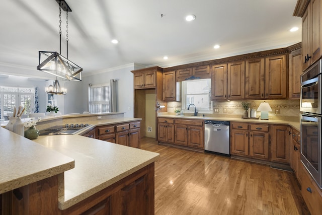 kitchen with a sink, light countertops, and stainless steel appliances