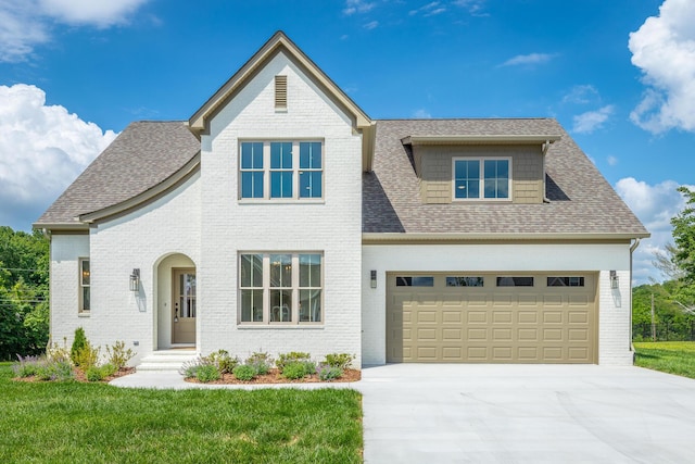 view of front of property featuring a garage and a front yard