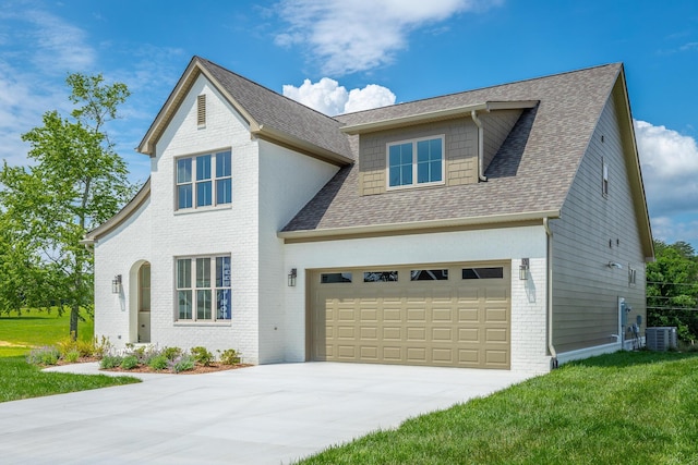 view of front of home with a garage, central air condition unit, and a front lawn