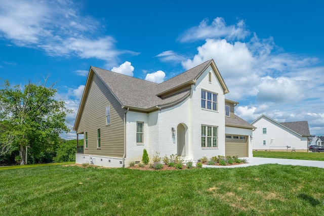 view of front of house with a garage and a front yard