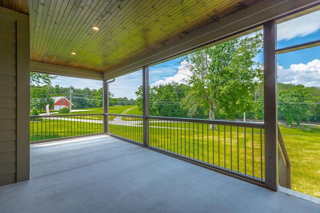 unfurnished sunroom with wood ceiling