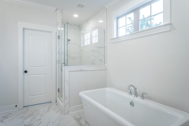 bathroom with crown molding and separate shower and tub