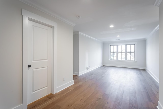 empty room featuring hardwood / wood-style floors and crown molding