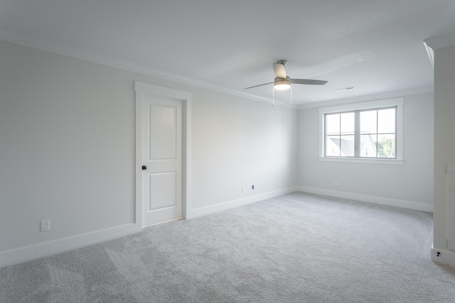 carpeted spare room featuring crown molding and ceiling fan