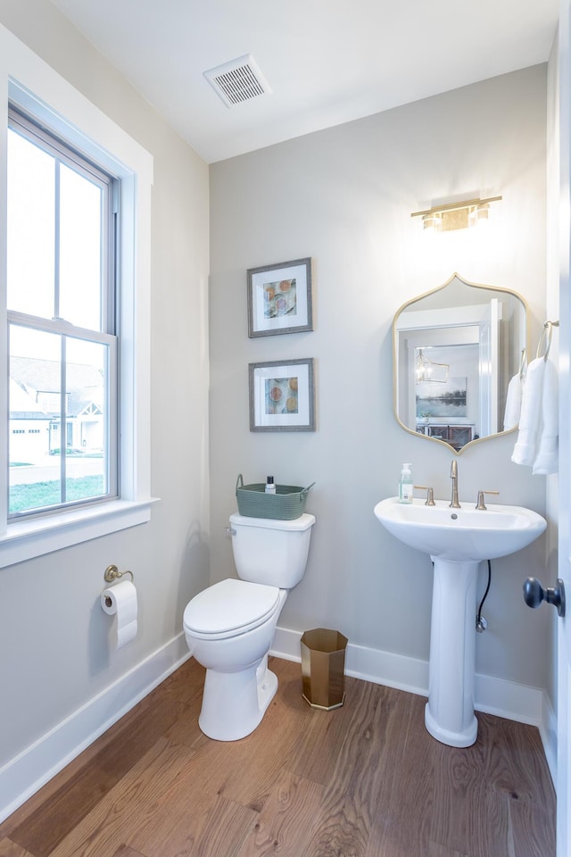 bathroom featuring hardwood / wood-style floors and toilet