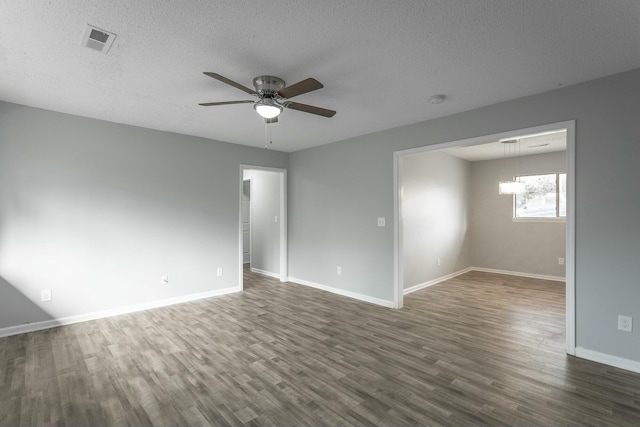 spare room featuring ceiling fan, dark hardwood / wood-style flooring, and a textured ceiling