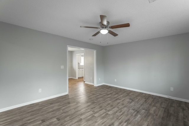 spare room with dark hardwood / wood-style flooring, a textured ceiling, and ceiling fan