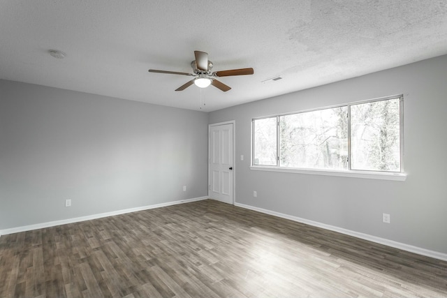 unfurnished room with hardwood / wood-style floors, a textured ceiling, and ceiling fan