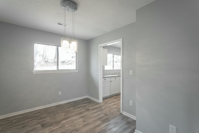 empty room with dark wood-type flooring and a textured ceiling