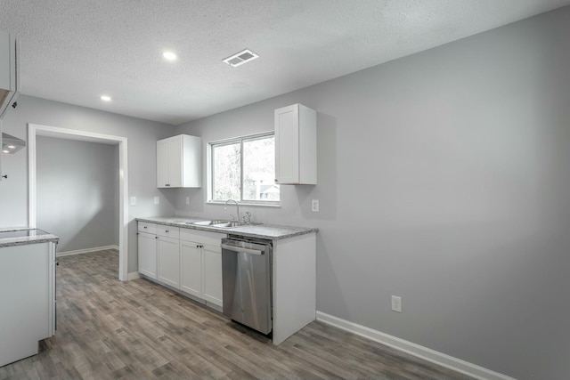 kitchen featuring white cabinetry, dishwasher, sink, and hardwood / wood-style floors