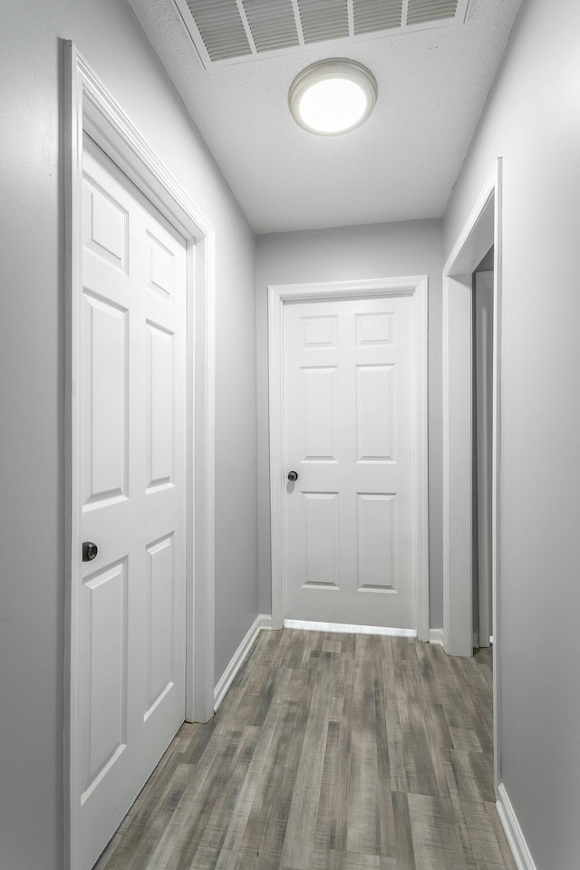 hallway with dark hardwood / wood-style floors