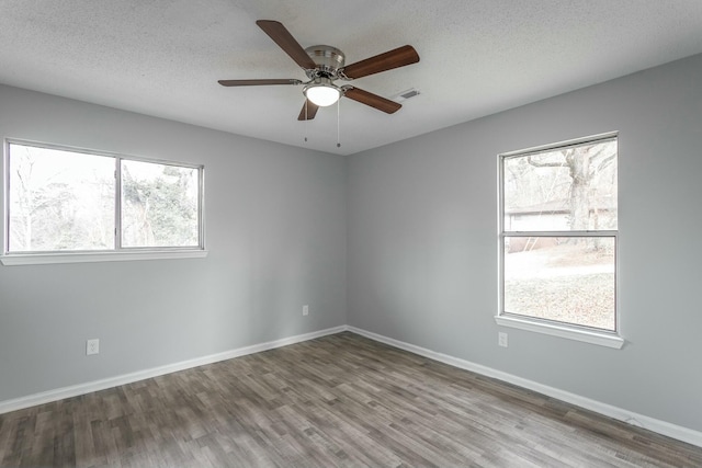 unfurnished room featuring hardwood / wood-style floors, a textured ceiling, and ceiling fan