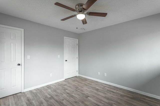 unfurnished bedroom with ceiling fan, hardwood / wood-style floors, and a textured ceiling