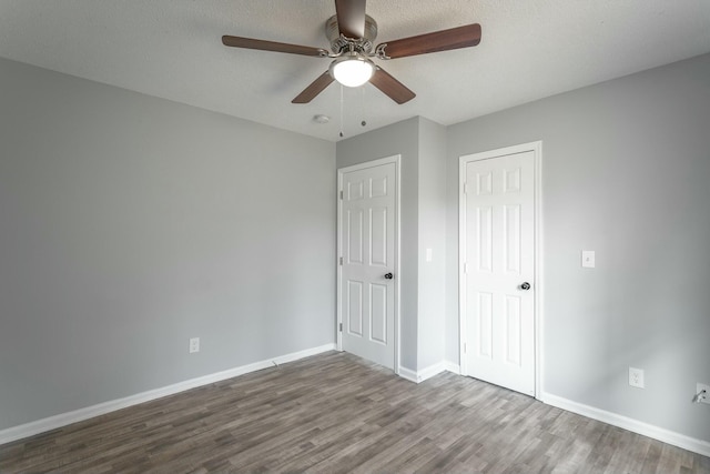 unfurnished bedroom featuring hardwood / wood-style floors, a textured ceiling, and ceiling fan