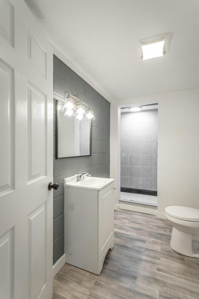 bathroom featuring vanity, hardwood / wood-style floors, and toilet