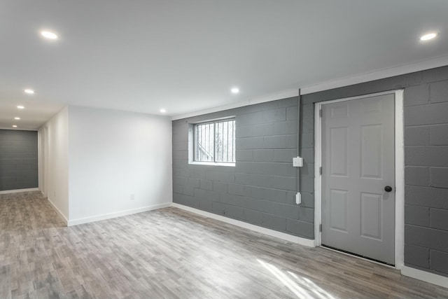 basement with light hardwood / wood-style flooring