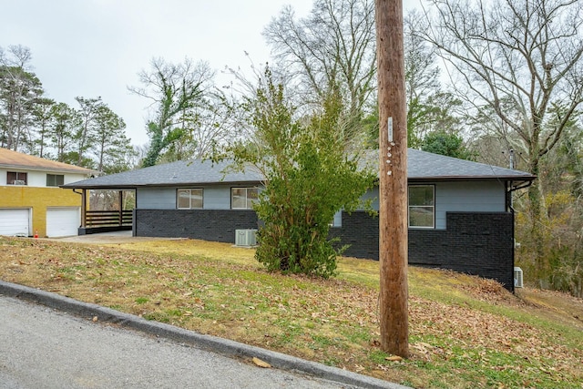 view of front of house with a garage and a carport