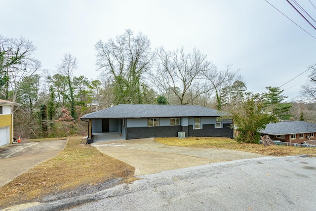 single story home with cooling unit and a carport