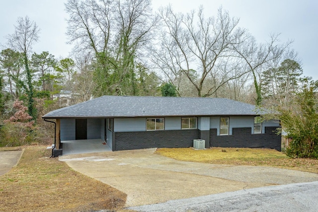 view of front of property featuring central AC and a carport