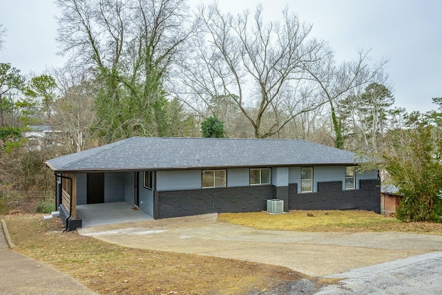 single story home with a carport and central AC unit